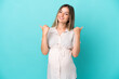 © luismolinero - Young Romanian woman isolated on blue background pregnant and with thumb up
