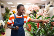 © Jelena - Young florist checking plants with tablet in flower shop