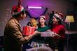 © Parichat - Friends exchanging Christmas gifts during a Christmas party