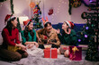 © Parichat - Group of friends singing christmas carols while playing acoustic guitar at home
