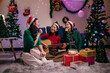 © Parichat - Friends singing christmas carols and playing guitar at home