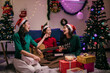 © Parichat - Group of friends having fun and singing Christmas songs at home