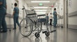© Hamid - An empty wheelchair sits in the middle of a brightly lit hospital hallway with blurred medical staff walking in the background, symbolizing healthcare and patient care.