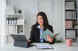 © Parichat - Businesswoman working with tablet and notebook in modern office