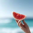 © SolaruS - Refreshing summer vibes Juicy watermelon slice held against a dreamy ocean backdrop. Captures the essence of vacation, healthy eating, and pure bliss. Perfect for travel or food blogs.