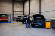 © Austockphoto - air conditioner technician talking with customer about car in workshop