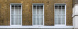 © Christian Ca - Classic Georgian Style Brick Building Facade with White Sash Windows and Traditional Architecture