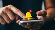 © Muin - Closeup of a persons hand holding a smartphone, with a notification bell icon appearing on the screen, indicating an alert or message