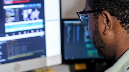 Person concentrating on computer screens