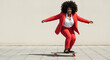 © Tamaras Pictures 4U - Confident black woman skateboarding in a red suit on urban pavement