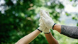 © Katawaredoki - Hand of volunteers people teamwork together for charity work join for cooperation success sustainable development goals on nature background in world environment day global and ESG concept