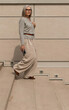 © Ivan Traimak - Woman walking gracefully down stone steps in a modern architectural setting during daylight