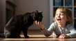 © Thoriqprabu - Joyful interaction: Little girl sharing her snack with her sleek black cat companion