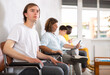 © JackF - Young guy in casual clothes sitting in lobby of medical clinic, waiting for appointment with doctor