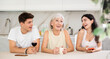 © JackF - Cheerful elderly mother having good time with adult children drinking tea in live room