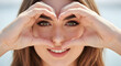 © Karmiyem - Woman making heart shape with hands beautiful eyes love romantic gesture valentines day feeling happy positive emotion pretty girl attractive female model skincare beauty cosmetics healthy lifestyle
