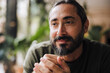 © Westend61 - Thoughtful man with beard in cafe