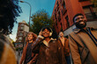 © bernardbodo - Group of young students walking and listening to music in Madrid