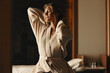 © Jacob Lund - Woman relaxing in a hotel spa wearing a bathrobe, enjoying a moment of calm