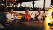 © Jacob Lund - Friends enjoying a gourmet dining experience at a stylish restaurant setting