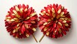 © リリ - 赤と金の羽根のような素材で作られたチアリーディング用のポンポン。鮮やかで華やかな印象を与えるスポーツ応援アイテムの写真