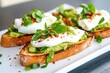 © dashtik - Fresh avocado toast with sunny-side up egg and basil on artisan bread