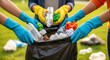 © Aurora Aesthetics - A diverse group of volunteers' hands working together to clean up a park by collecting plastic waste