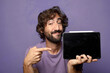 © kues1 - young adult bearded man holding a touch screen pad