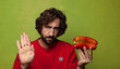 © kues1 - young adult bearded man with a red pepper
