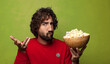 © kues1 - young adult bearded man. popcorns and movie concept