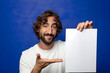 © kues1 - young adult bearded man holding a sheet of paper