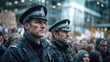 © Ruslan Gilmanshin - Two serious-looking British police officers stand guard at a protest, looking forward with professionalism and duty as snow falls lightly on their uniforms and hats