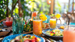 © EwaStudio - Outdoor vegan dining setup with colorful dishes and fresh juices