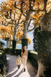 © Doralin - Mother and daughter walking in a beautiful park on lake como during autumn