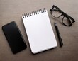 © Cory - blank notepad smartphone eyeglasses on a desk flat lay