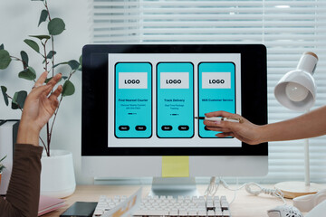 Wall Mural - uiux designers collaborating on creating a new mobile application interface for an innovative delive