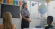 © Framestock - American Female TSA Security Officer Explaining Safety Rules to Young Students at Elementary School. Children Sitting, Listening to Police Worker Guidance About Knowledge of Law and Responsibility.
