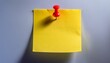 © Michael - a single yellow sticky note stuck on a wall or surface with a red pin holding it in place
