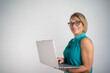 © Nenad - Beautiful smiling businesswoman using laptop on isolated background, professional female worker technology and business