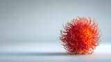 Red rambutan with spiky hairs casts shadow on soft gradient background