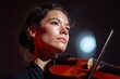 © KASUEMA SALAE - A professional violinist performing an emotional solo on a grand stage with elegant lighting