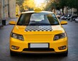 © Charles - a yellow taxi cab with a black and white checkered pattern on the side
