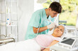 © JackF - Young male cosmetologist performs hardware facial cleansing procedure to young woman patient