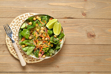 Wall Mural - Plate with fresh salad on wooden background