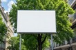 Blank billboard ready for advertisement in urban city with green trees and bright sunlight