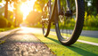 © HumblePride - Cycling into the Sunlight: A bicycle travels along a paved path, its front wheel in sharp focus against the backdrop of vibrant sunlight, inviting you to embark on a journey of adventure.