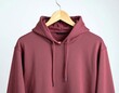 © Shin - A realistic mockup of a plain unisex hoodie hanging on a wooden hanger against a white background
