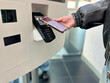 © Ina - Close-up of teenager paying for takeaway food using mobile phone contactless payment at self-service kiosk. Concept: cashless payments, modern technology, digital everyday life.