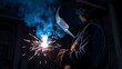 © Sampath - Welder working with sparks and protective gear on
