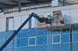 © Francesco Scatena - CONSTRUCTION LIFT PLATFORM ON MODERN GLASS BUILDING - Aerial work platform used for facade installation, window cleaning, maintenance and construction safety equipment on high rise building